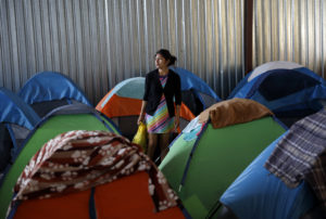 A woman from Guatemala, who did not give her name, waits at a shelter of mostly Mexican and Central American migrants to begin the process of applying for asylum Friday, April 12, 2019, in Tijuana, Mexico. The Trump administration is asking an appeals court to let it continue returning asylum seekers to Mexico hours before a U.S. judge's order was set to go into effect Friday afternoon reversing the unprecedented change to the U.S. asylum process. (AP Photo/Gregory Bull)