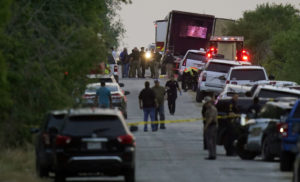 Police and other first responders work the scene where officials say dozens of people have been found dead and multiple others were taken to hospitals with heat-related illnesses after a semitrailer containing suspected migrants was found, Monday, June 27, 2022, in San Antonio. AP/Eric Gay