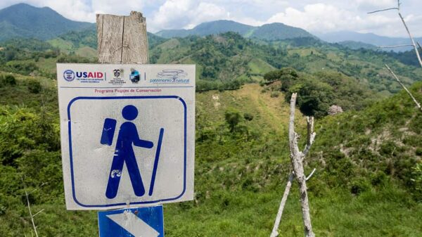 USAID sign in front of Colombian countryside